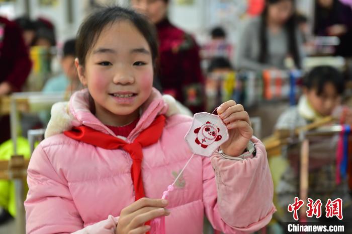 圖為一名小學(xué)生繡制的2022年北京冬奧會吉祥物“冰墩墩”形象?！∮髟屏?攝