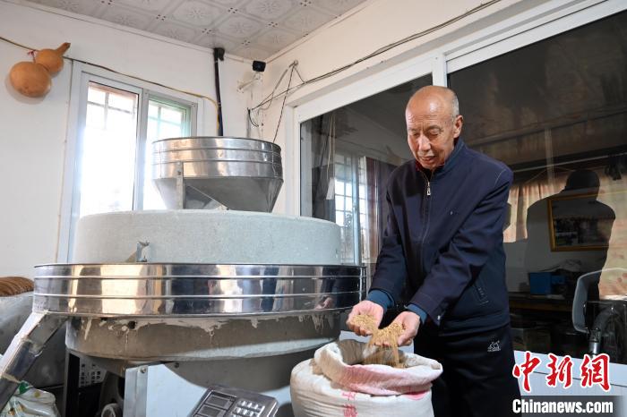 李家莊村民谷文朝重拾父輩的手藝，做起石磨面粉的營生?！〉杂鸺?攝