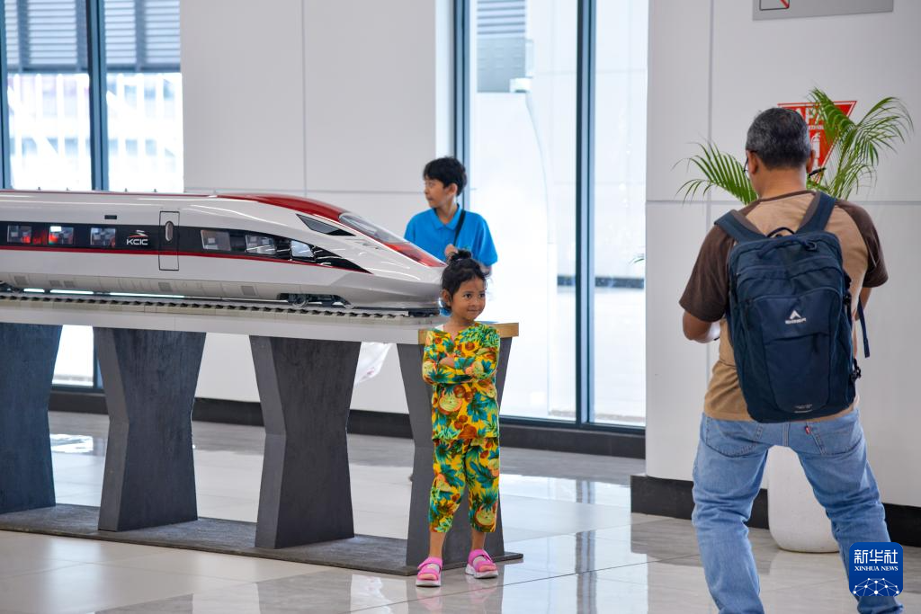 1月24日，在印度尼西亞雅加達(dá)哈利姆站候車大廳，一名小朋友和雅萬高鐵高速動(dòng)車組模型合影。新華社記者 徐欽 攝
