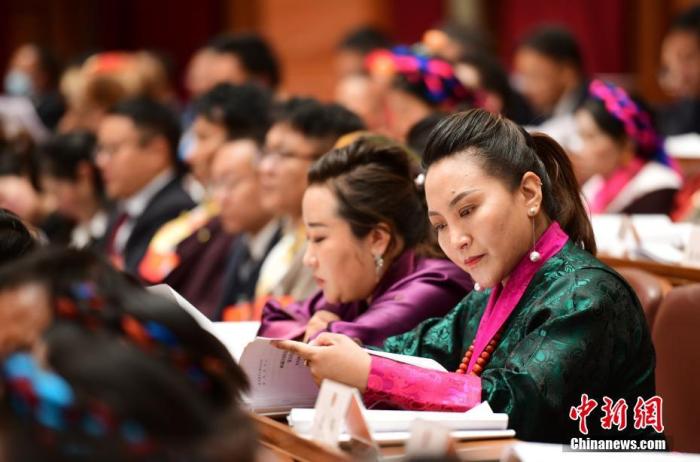 1月5日，次旦卓嘎(右一)在拉薩參加西藏自治區(qū)第十一屆人民代表大會第五次會議第二次全體會議。西藏自治區(qū)人大代表次旦卓嘎來自日喀則市定日縣，定日縣被稱為“洛諧故鄉(xiāng)”，作為西藏民間歌舞，洛諧已被列入中國國家非物質(zhì)文化遺產(chǎn)項目名錄，這是集歌、舞、樂、彈唱于一體的綜合藝術(shù)形式。參加完西藏2022年新年音樂會的次旦卓嘎告訴記者，每年參加的基層演出可達(dá)80場，“我希望用最純粹的方式，把最好的聲音帶到西藏乃至中國的各個角落?！?<a target='_blank' href='/'><p  align=