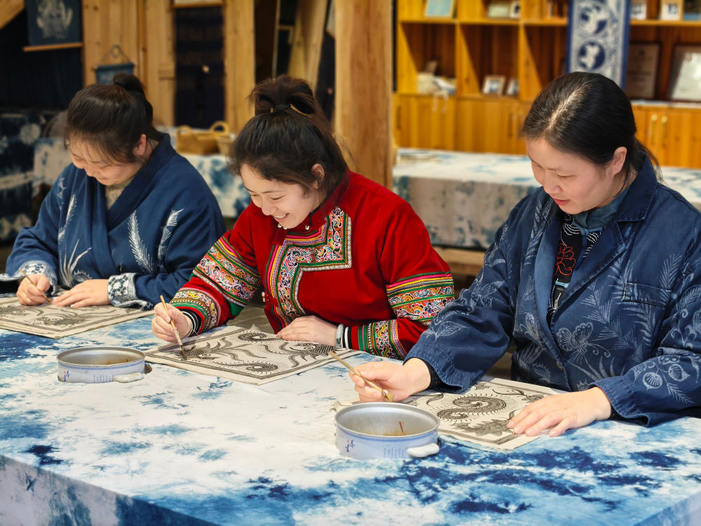 2025年3月14日，村民在肇興侗寨內(nèi)制作蠟染。圖片來源：新華社