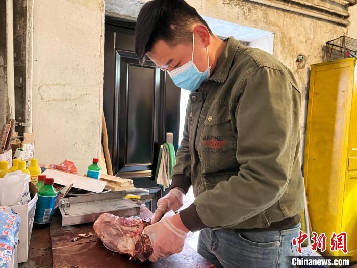 圖為雪豹“奶爸”史壽軍正在準(zhǔn)備投喂雪豹的食材?！●R銘言 攝