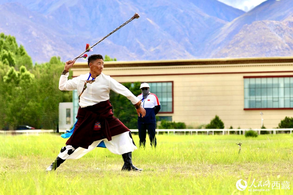 參賽選手在拉薩首屆農(nóng)牧民運(yùn)動(dòng)會(huì)上進(jìn)行“古朵”比賽（“古朵”指的是用牦牛毛或者山羊毛編織成的拋石繩，可以將石頭投擲到較遠(yuǎn)的地方，是牧民們用來放牧的工具）。